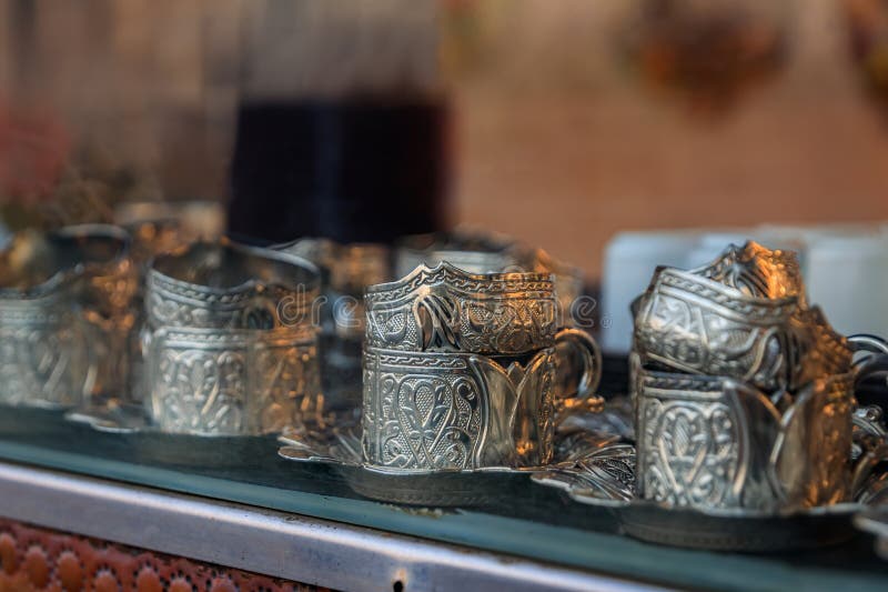 Ornate handmade silver coffee cup holders at a traditional Turkish street coffee house cart in Eminonu Istanbul, Turkey. Ornate handmade silver coffee cup holders at a traditional Turkish street coffee house cart in Eminonu Istanbul, Turkey