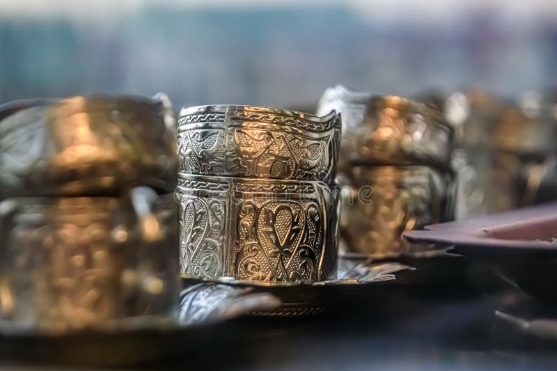 Ornate handmade silver coffee cup holders at a traditional Turkish street coffee house cart in Eminonu Istanbul, Turkey. Ornate handmade silver coffee cup holders at a traditional Turkish street coffee house cart in Eminonu Istanbul, Turkey