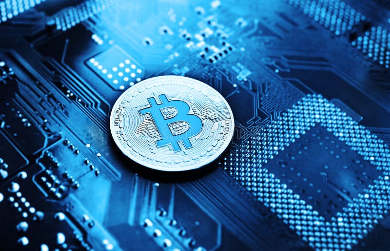 Silver coin bitcoin on a microchip background. stock images