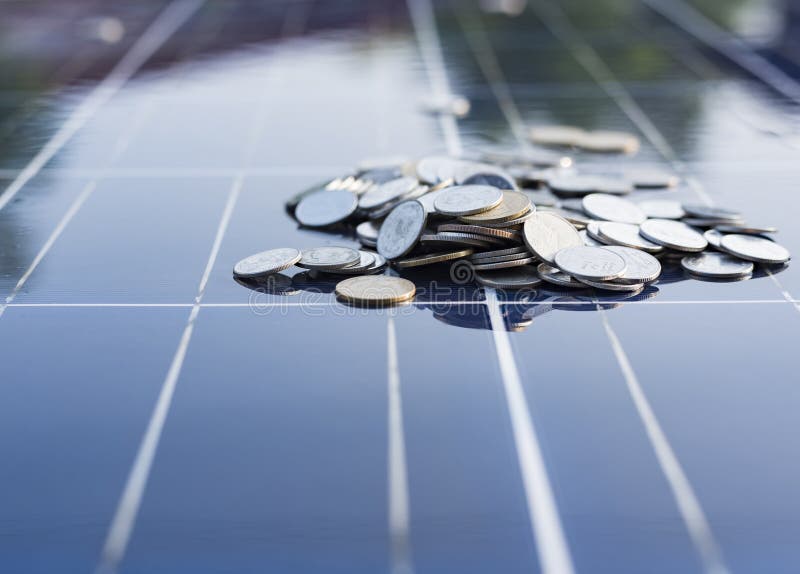 Silver Coins on the Solar Panel Help Store Solar Energy Stock Image