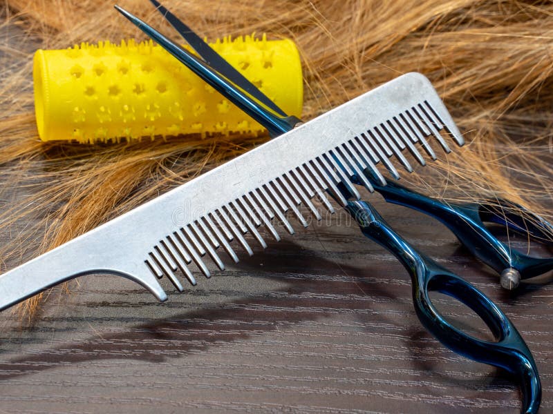 Silver comb hairdressing scissors and curlers royalty free stock photo