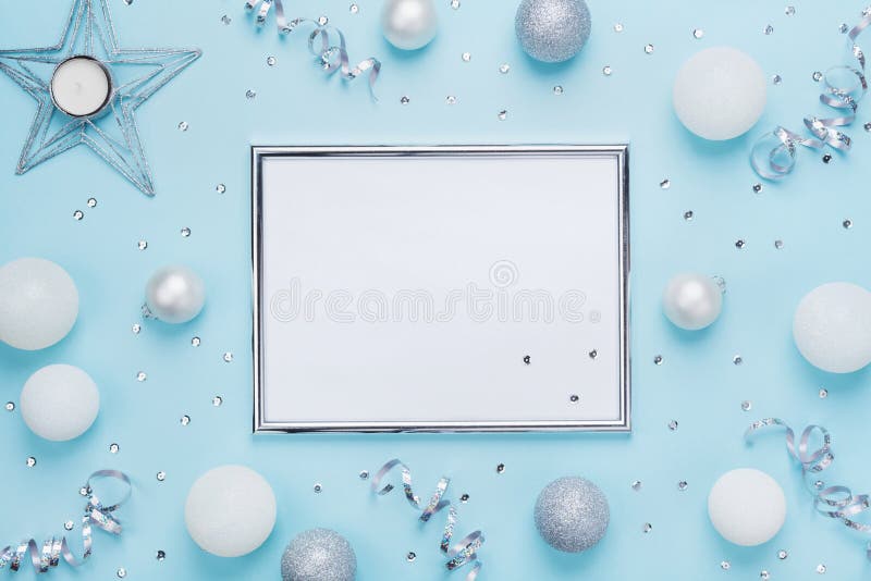 Silver frame and christmas decoration on stylish blue table top view. Fashion background. Flat lay. Party mockup, invitation. Silver frame and christmas stock photo Silver frame and christmas decoration on stylish blue table top view. Fashion background. Flat lay. Party mockup, invitation. Silver frame and christmas stock photo