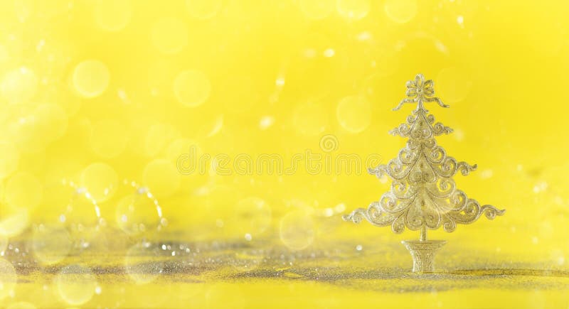 Silver glitter Christmas tree on yellow background with lights bokeh, copy space. Greeting card for new year party. Festive royalty free stock photography Silver glitter Christmas tree on yellow background with lights bokeh, copy space. Greeting card for new year party. Festive royalty free stock photography