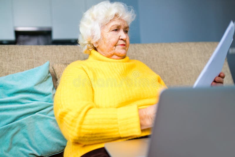 Silver Haired Mature Russian Unhappy Woman Holding At Banking Paper