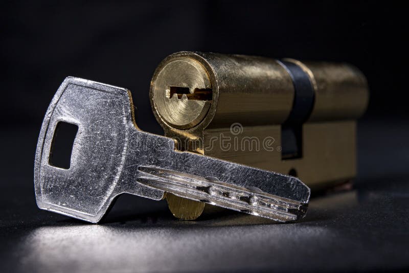 Silver keys and a lock for the front door. Household security system stock images