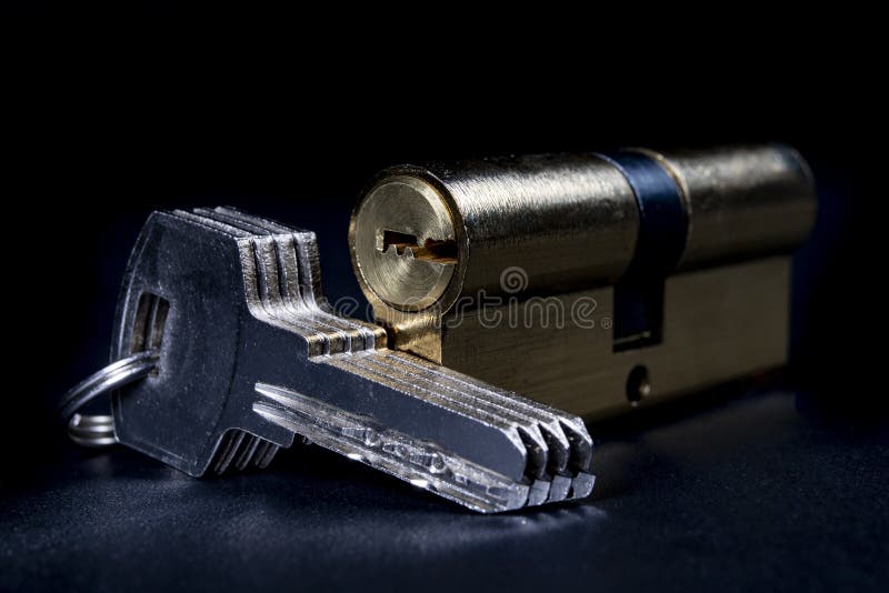 Silver keys and a lock for the front door. Household security system stock photography