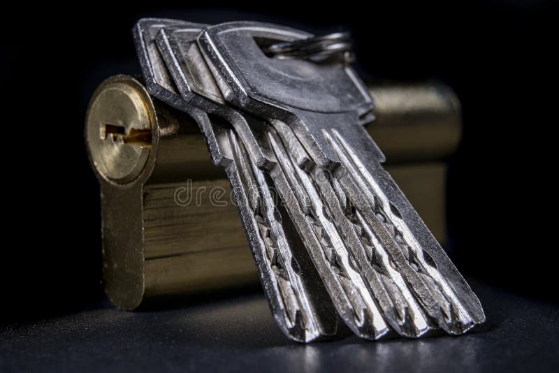 Silver keys and a lock for the front door. Household security system royalty free stock images