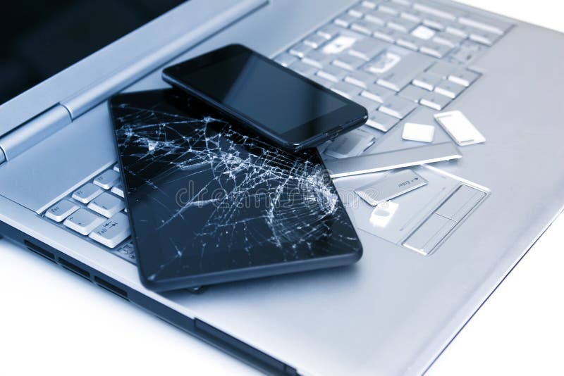 A Silver Laptop with a Broken Keyboard, Tablet with a Display and Black Phone. a Close-up Picture of Part of Broken Laptop Stock Photo - Image broke, electronic: 149878144