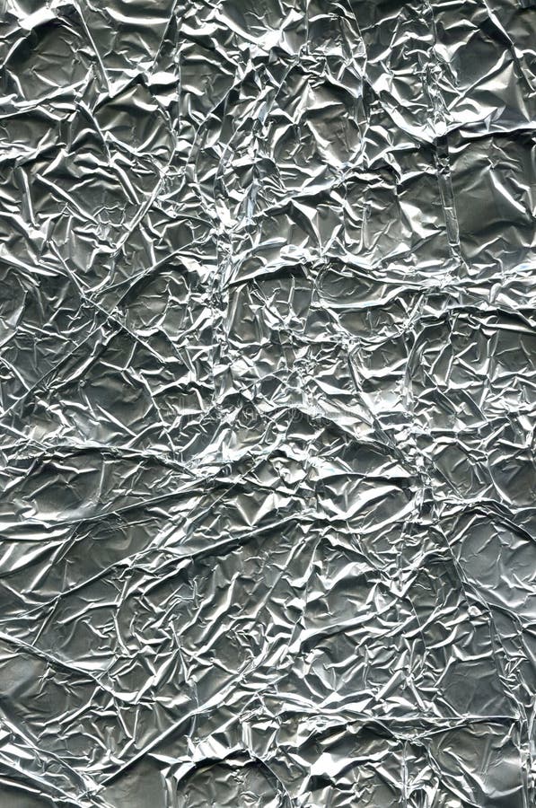 Silver Leaf Foil Background With Shiny Crumpled Uneven Surface For