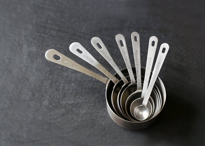 Silver Measuring Cups Stacked on Black Background