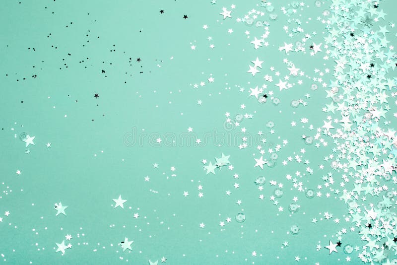 Silver and pink star glitter on teal pastel background.