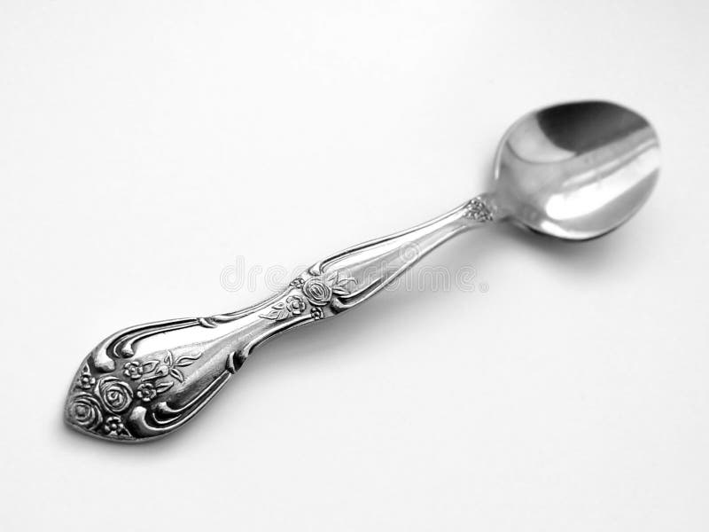 Silver spoon on isolated white background