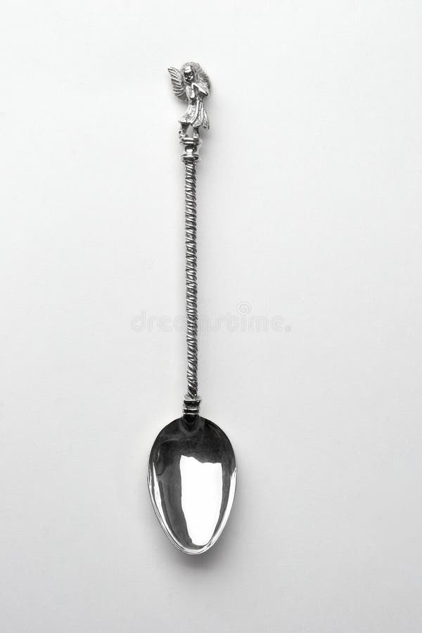 Single Silver spoon with angel on a white background