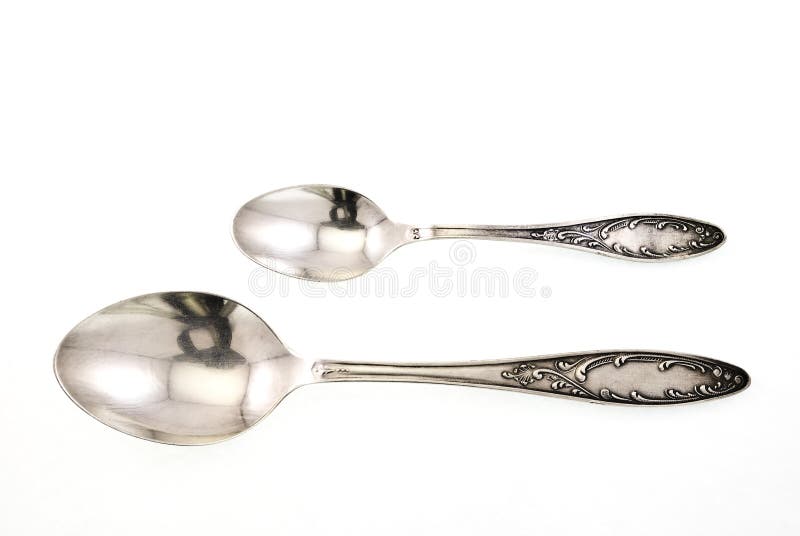 Silver spoon and teaspoon on white