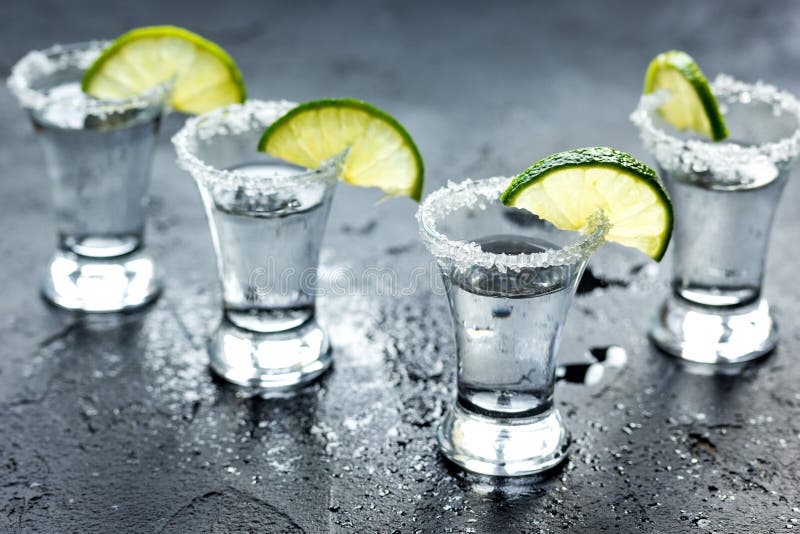 Tequila Shot with Lime Slices and Salt on Dark Background Stock Photo ...