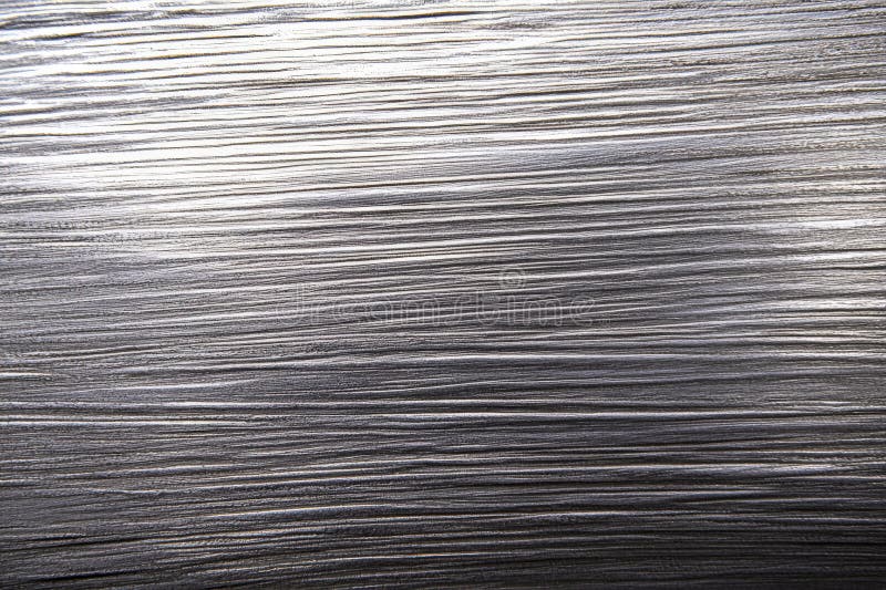 A silver textured surface with a soft, brushed finish, showcasing fine, parallel lines that add a stock image