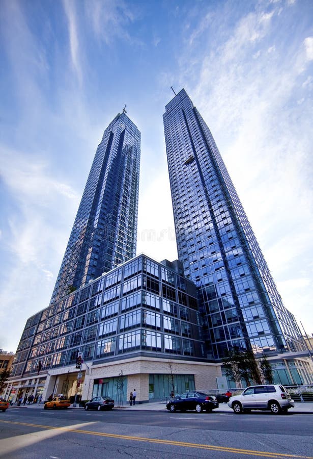 The Silver Towers are twin residential buildings in Hell's Kitchen, Manhattan. The 60-story buildings stand on the west side of Eleventh Avenue between 41st Street and 42nd Street near the Hudson River and contain 1,359 units. The project includes a 75-foot pool, the largest in a New York City residential building as well as a quarter-acre public park on the west side of the towers. The Silver Towers were completed in June 2009. Larry Silverstein, who developed the buildings, bought the block between 42nd and 41st Streets between 11th and 12th Avenues in 1984 for $20 million. At the time the site was vacant and zoned for single story industrial use. The block was rezoned in 1989 and One River Place, a 41-story residential high rise on the west end opened in 2000. In 2000, Silverstein contemplated developing an office building on the east end of the block. A few years later, the site was considered as the location for a 1,500 room hotel as part of the plans to expand the Jacob K. Javits Convention Center. Costas Kondylis is the architect for the Silver Towers, who also designed One River Place. The original design called for a single large residential building (Two River Place) like its neighbor on the west end of the block. However it was changed to two buildings to make the halls seem more intimate. The Silver Towers are twin residential buildings in Hell's Kitchen, Manhattan. The 60-story buildings stand on the west side of Eleventh Avenue between 41st Street and 42nd Street near the Hudson River and contain 1,359 units. The project includes a 75-foot pool, the largest in a New York City residential building as well as a quarter-acre public park on the west side of the towers. The Silver Towers were completed in June 2009. Larry Silverstein, who developed the buildings, bought the block between 42nd and 41st Streets between 11th and 12th Avenues in 1984 for $20 million. At the time the site was vacant and zoned for single story industrial use. The block was rezoned in 1989 and One River Place, a 41-story residential high rise on the west end opened in 2000. In 2000, Silverstein contemplated developing an office building on the east end of the block. A few years later, the site was considered as the location for a 1,500 room hotel as part of the plans to expand the Jacob K. Javits Convention Center. Costas Kondylis is the architect for the Silver Towers, who also designed One River Place. The original design called for a single large residential building (Two River Place) like its neighbor on the west end of the block. However it was changed to two buildings to make the halls seem more intimate.