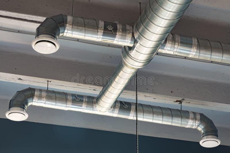 Silver Ventilation Pipes Hanging from the Ceiling Inside the Building