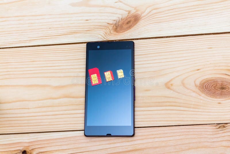 SIM Cards of Different Form Factor on the Smartphone Stock Photo