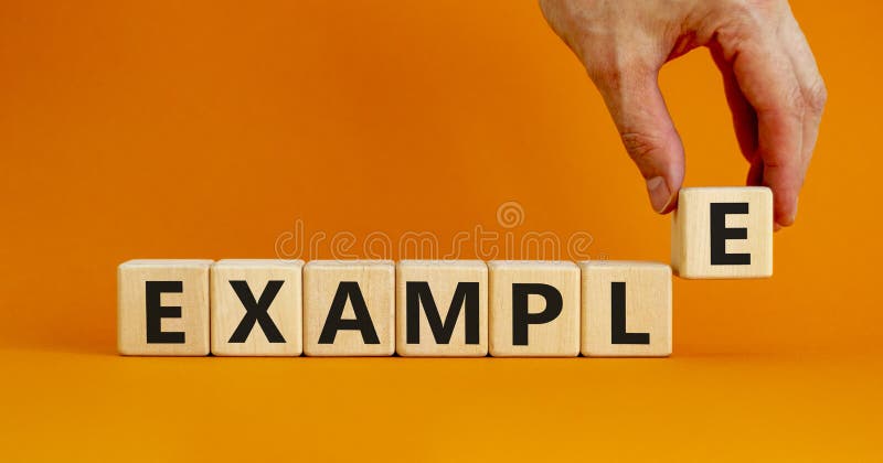 Simbol exemplu. concept word example on wood cubes. fundal portocaliu pentru o masă portocalie de culoare portocalie frumoasă, spa royalty free stock photos