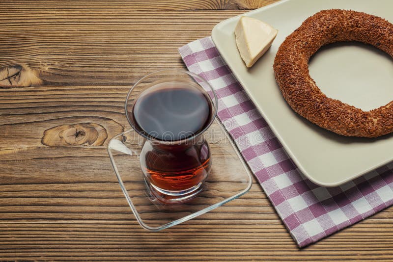 Simit - turkish bagel, tea and cheese on wood table royalty free stock image
