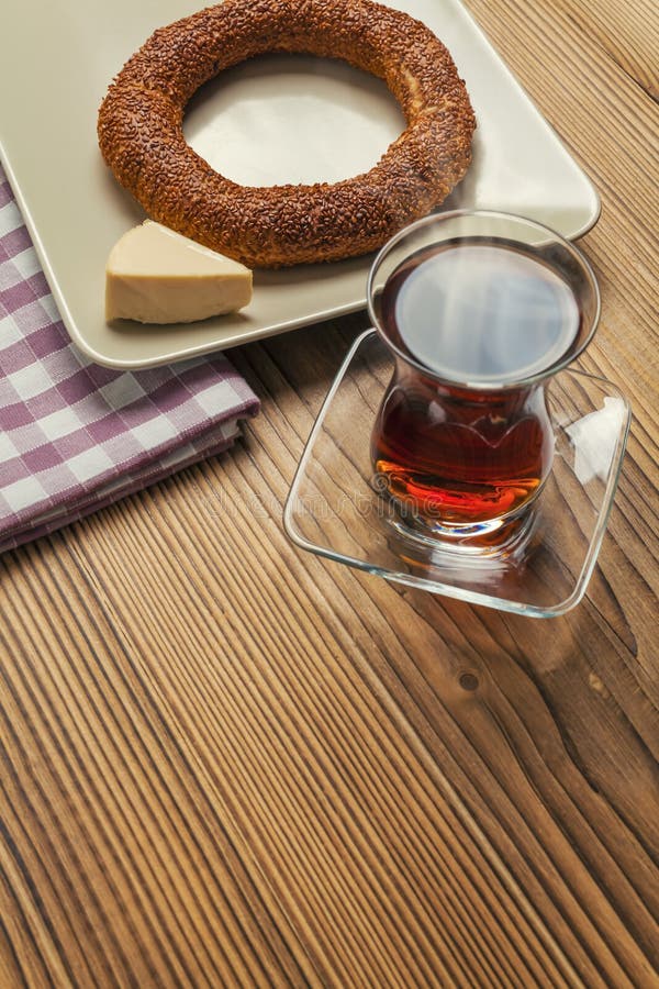 Simit - turkish bagel, tea and triangle cheese on wood table stock photography