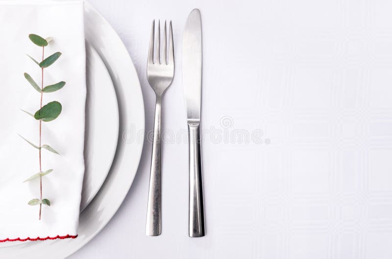 Simple Dinner Setting, Green Stem on Napkin with Plain Crockery Stock