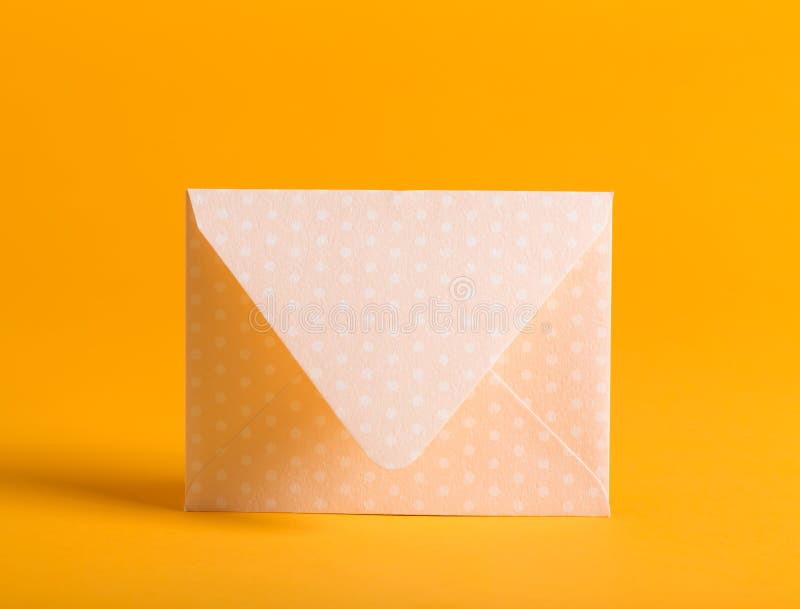 Envelope on a yellow background stock photo Envelope on a yellow background stock photo