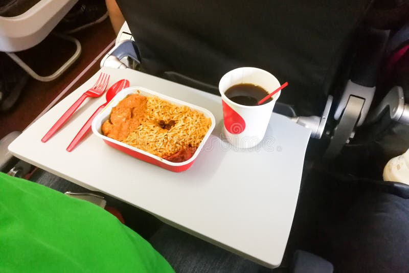 Simple inflight Meal of Rice, Meat, Coffee in Disposable Utensils