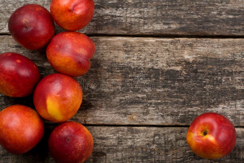 The simple food composition with nectarines on the unique backing closeup