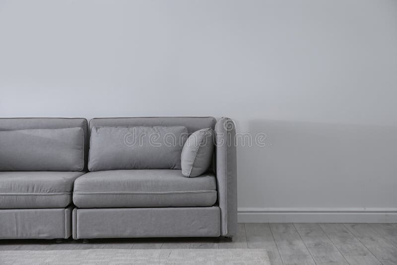 Simple Living Room Interior with Comfortable Sofa Near Light Wall Stock  Photo - Image of background, comfort: 136719054