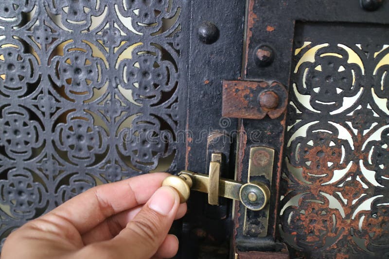 Simple lock on scrap metal window stock image