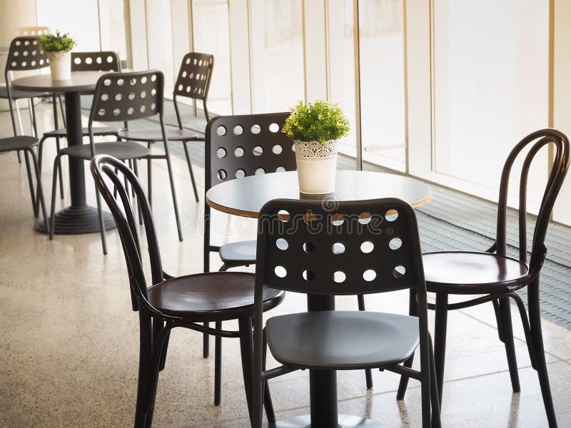 Simple Retro Style Coffee Shop Interior With White And Black Chairs