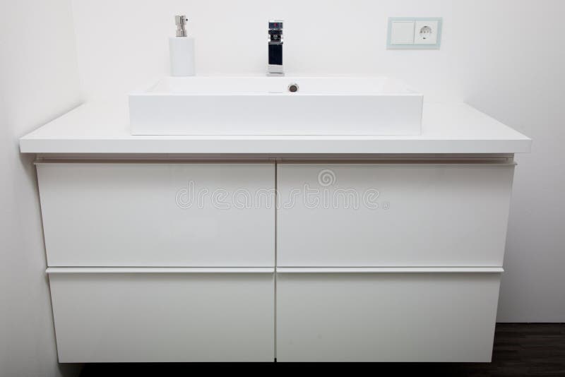 Simple white bathroom cabinet and hand basin royalty free stock images Simple white bathroom cabinet and hand basin royalty free stock images