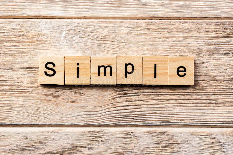 Simplify word written on wood block Simplify motivation text on - stock  photo 3150738