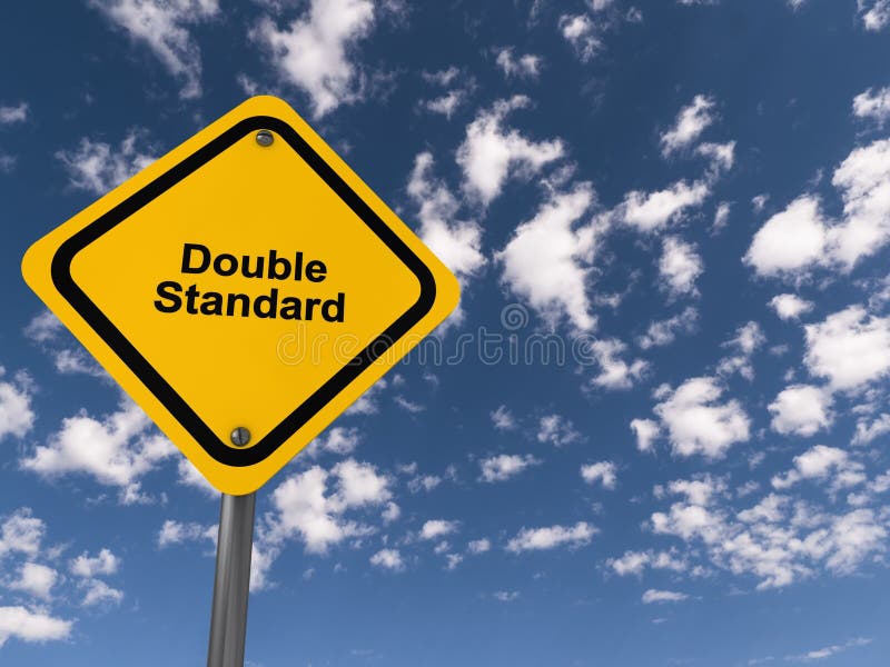 Double Standard traffic sign on blue sky background. Double Standard traffic sign on blue sky background