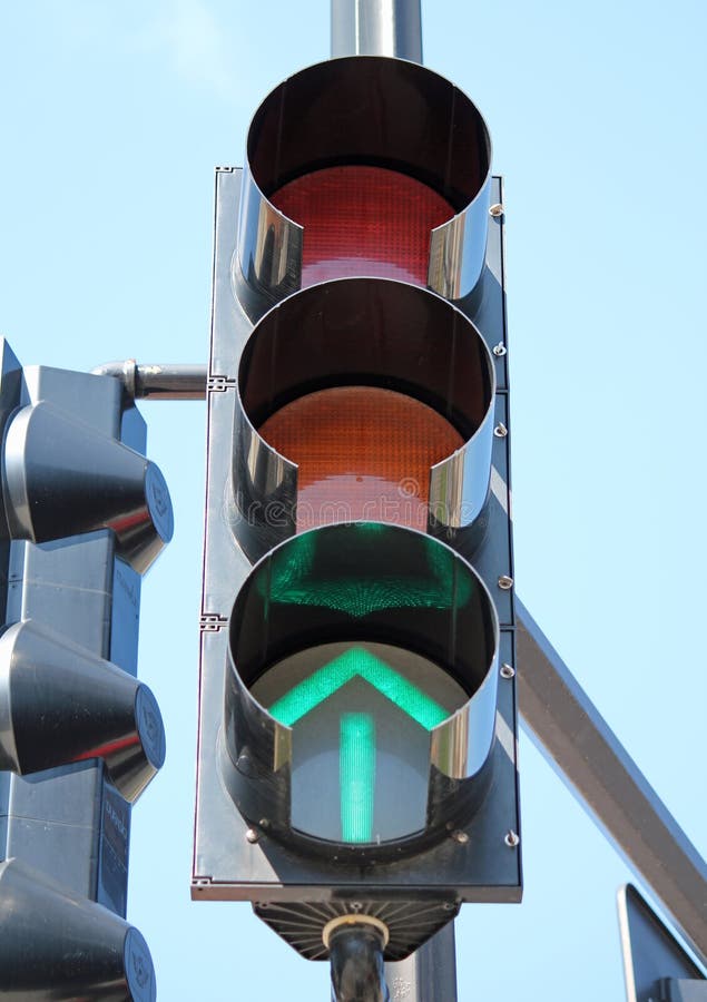 A traffic signal with a glowing green arrow. A traffic signal with a glowing green arrow