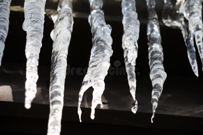 Closeup of icicles hanging off a roof in the sunlight. Closeup of icicles hanging off a roof in the sunlight