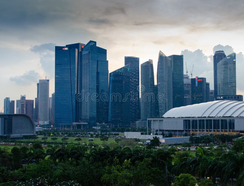 Singapore - 28 aprile 2014: Grattacieli di una città asiatica al tramonto fotografia stock libera da diritti Singapore - 28 aprile 2014: Grattacieli di una città asiatica al tramonto fotografia stock libera da diritti