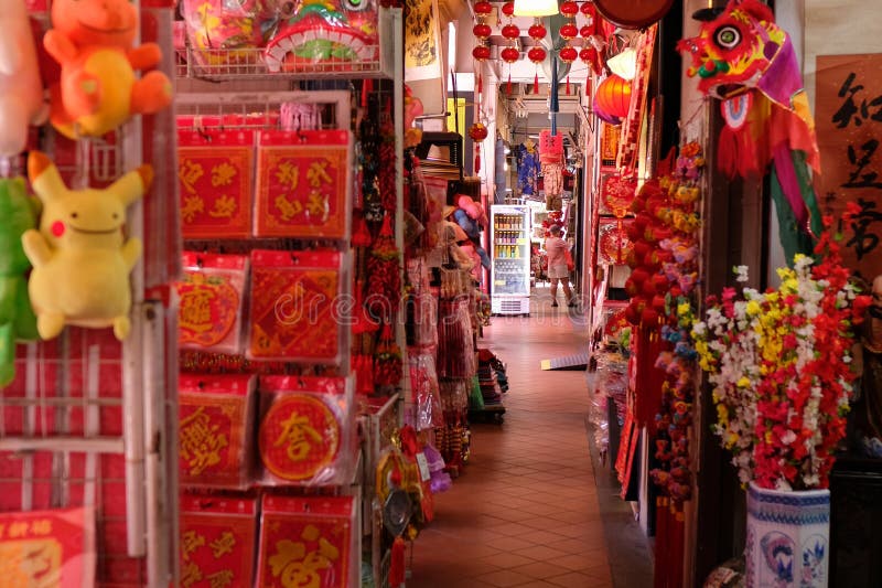 Singapore, Jan 1 2019 - Crowded colourful display of Chinese New Year decorations and ornaments for sale along a shop corridor in Chinatown _. Singapore, Jan 1 2019 - Crowded colourful display of Chinese New Year decorations and ornaments for sale along a shop corridor in Chinatown _