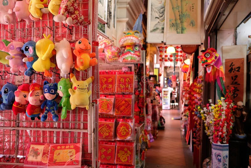 Singapore, Jan 1 2019 - Crowded colourful display of Chinese New Year decorations and ornaments for sale along a shop corridor in Chinatown _. Singapore, Jan 1 2019 - Crowded colourful display of Chinese New Year decorations and ornaments for sale along a shop corridor in Chinatown _