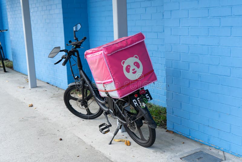 Singapore - July 19, 2022: Foodpanda rider`s bicycle was parked beside the road.