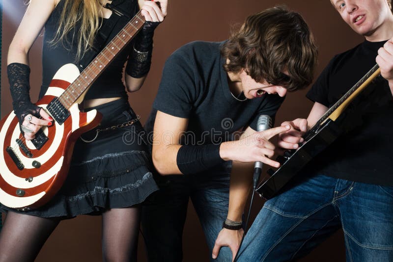 Funny singer and rock band in photostudio