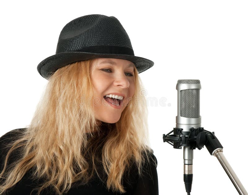 Female singer in black hat singing with studio microphone. Isolated on white background. Female singer in black hat singing with studio microphone. Isolated on white background.