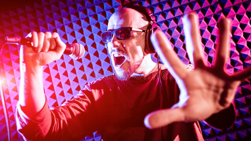 The singer sings with a microphone in the recording studio. royalty free stock photos