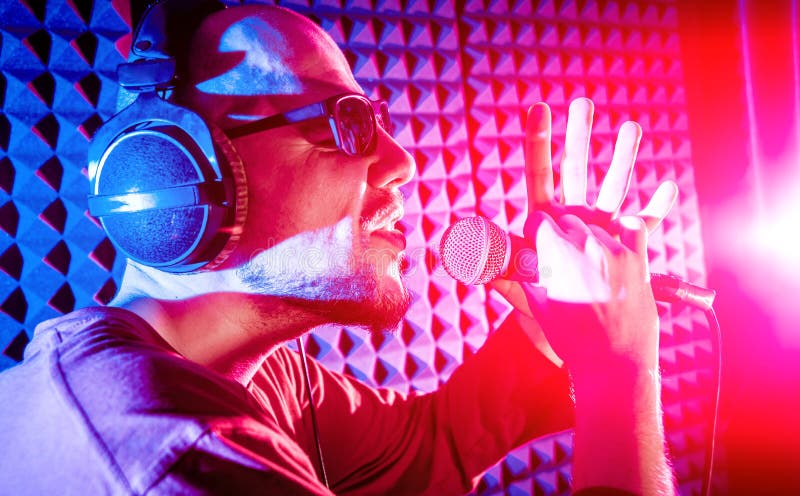 The singer sings with a microphone in the recording studio. royalty free stock photos