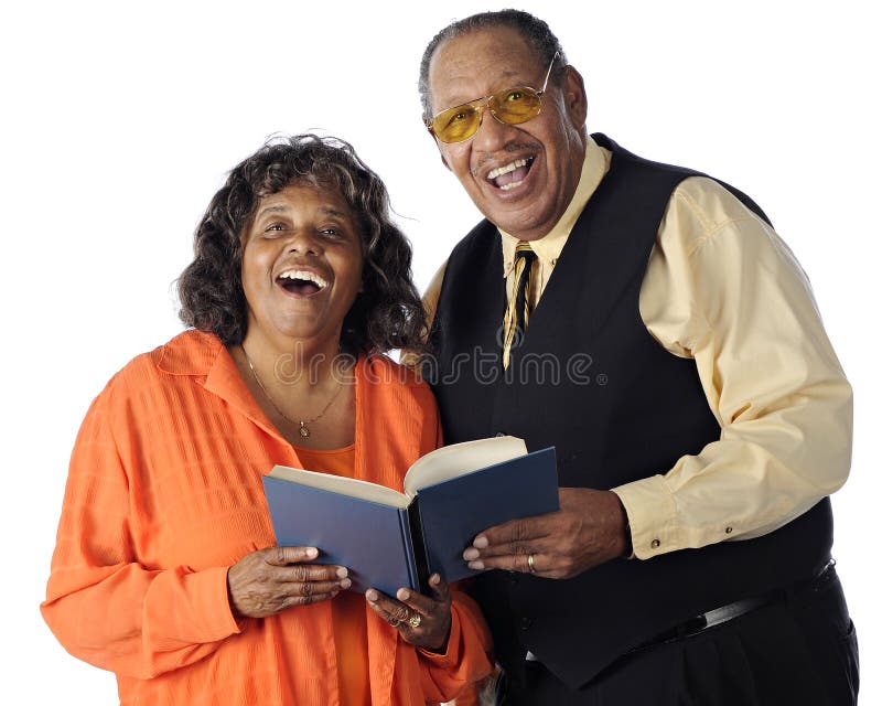 A senior African American couple sing together from a songbook. On a white background. A senior African American couple sing together from a songbook. On a white background.