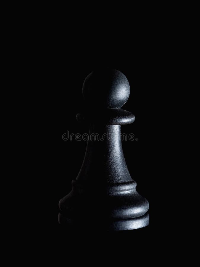 Single black chess piece pawn on black, dramatic lighting. Manipulation, powerlessness, hidden victim concept.