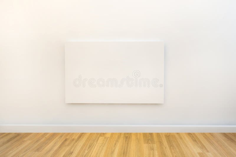 Single blank canvas hanging on a white gallery or studio wall stock photography