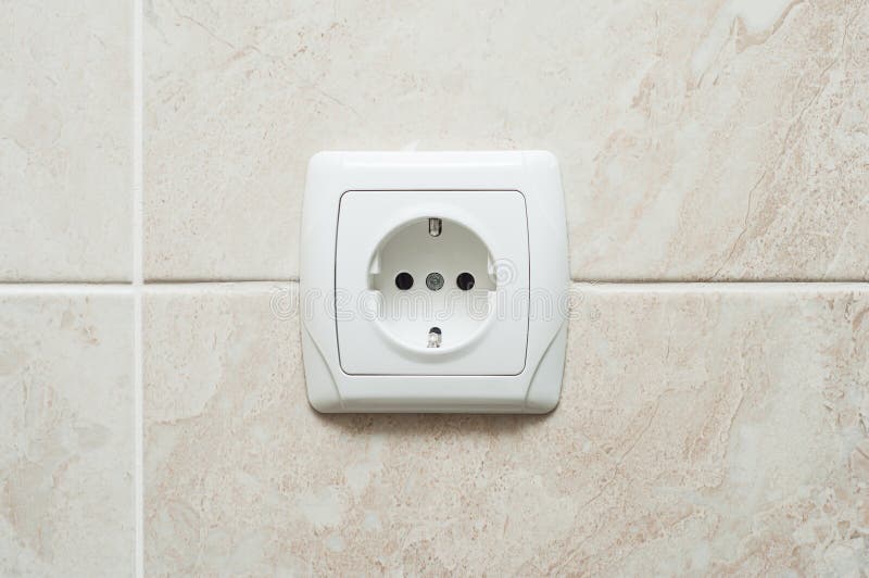 Single Electric European Outlet on the Wall with Wallpaper Near the